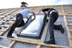 two-men-assembling-a-roof-skylight-window-2022-09-23-16-16-27-utc.jpg