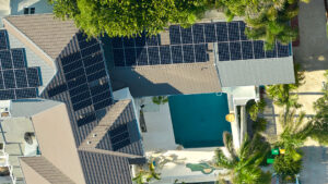 aerial-view-expensive-american-home-roof-with-blue-solar-photovoltaic-panels-producing-clean-ecological-electric-energy-investing-renewable-electricity-retirement-income (1)